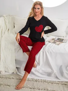 Cozy women's two-piece pajama set featuring a heart patch top and checkered pants.
