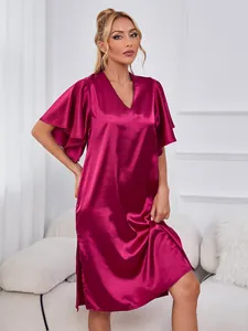Detail view of a magenta satin V-neck nightgown with flutter sleeves and side slits.
