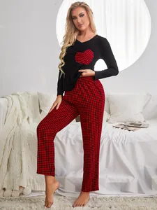 Women's pajama set featuring a heart-patterned long-sleeve top and red plaid pants