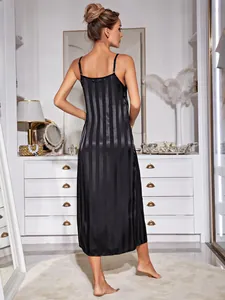 Elegant black striped satin slip nightgown shown from the back in a stylish bedroom
