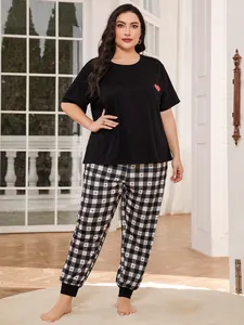 Full view of women's plus size pajama set with heart print top and checkered pants