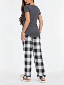 Back view of women's grey short sleeve top and black checkered pajama pants set
