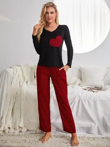 Cozy women's black long-sleeve pajama top featuring a red buffalo plaid heart patch