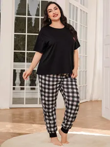 Plus size women's pajamas set featuring black short sleeve tee and plaid heart pants