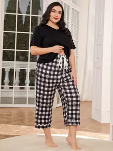 Plus size pajamas set featuring a black t-shirt and heart-patterned checkered pants.