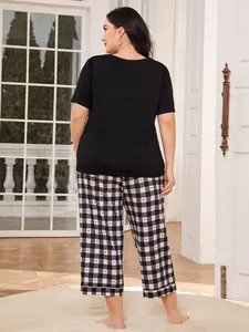 Back view of plus-size black short sleeve t-shirt and plaid pajama pants