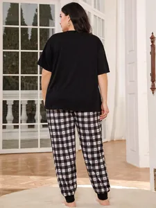 Rear view detail of plus size pajama set featuring black top and heart checkered pants