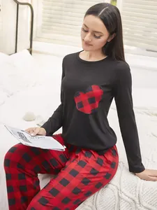 Cozy black long-sleeve pajama top featuring a red plaid heart patch and buffalo check pants