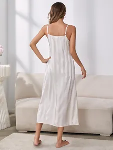 Back view of elegant white striped satin camisole nightgown in a cozy home setting
