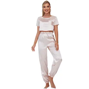 Two-piece blush satin pajama set with crop top and jogger pants for women's sleepwear