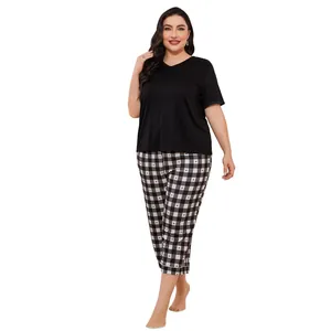 Plus size women's pajama set features a black V-neck top and heart-patterned plaid pants