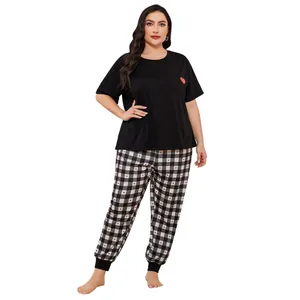 Comfortable plus size women's pajama set with black heart t-shirt and checkered pants.