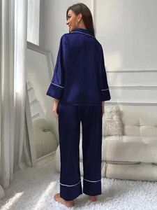 Elegant back view of women's navy blue satin pajama set with long sleeves and pants