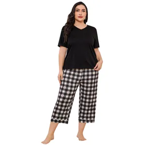Detail of plus size women's loungewear set with black top and heart-checkered pants