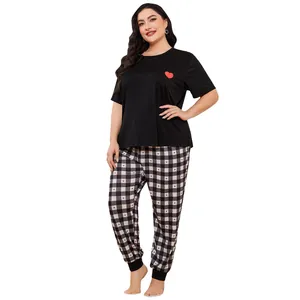 Plus-size women's pajama set featuring heart-print t-shirt and checkered pants on model