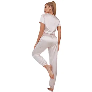 Back view of women's champagne satin pajama set with short sleeve top and jogger pants.