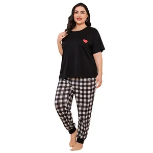 Full body view of plus-size women's pajama set with heart print and checkered pants