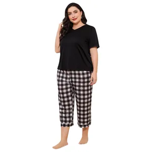 Plus size pajama set featuring black short sleeve top and heart pattern plaid pants