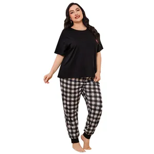 Plus size women's pajama set featuring a black short sleeve top and heart checkered pants