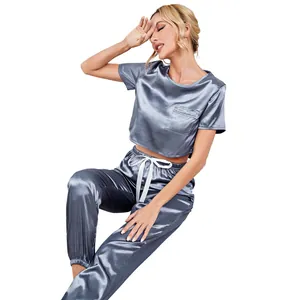 Detailed view of women's silver satin pajama set with crop top and drawstring pants