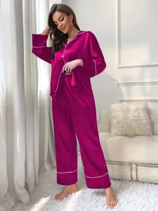 Elegant fuchsia satin long-sleeve pajama set with white piping and loose-fit pants