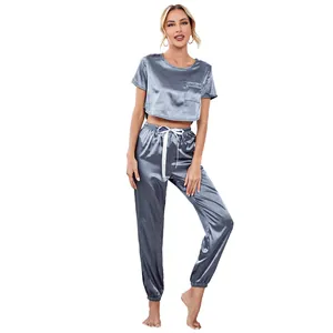 Two-piece satin pajama set with short sleeve crop top and jogger pants in blue