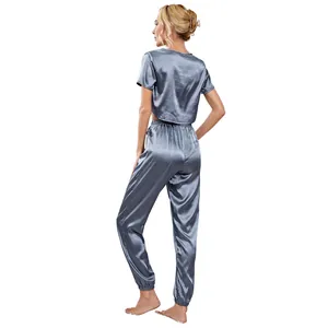 Detailed back view of a grey-blue satin pajama set with crop top and jogger pants