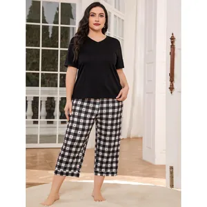 Plus size women's loungewear set with black V-neck top and heart-patterned checkered pants