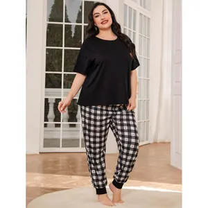 Plus size women's pajama set with black short sleeve top and heart plaid lounge pants