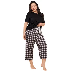 Plus size women's pajama set with black short sleeve top and plaid heart print pants