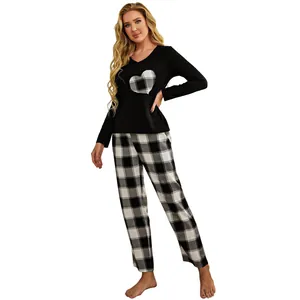 Women's black plaid pajama set featuring long sleeve heart top and matching trousers