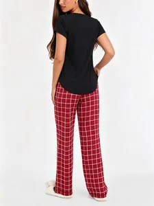 Back view of women's pajama set featuring black t-shirt and red plaid pants.
