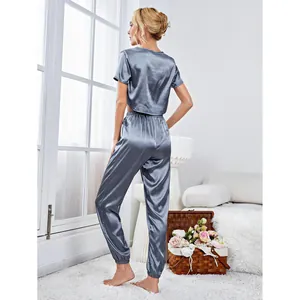 Women's 2-piece satin pajama set with short-sleeved crop top and jogger pants in grey
