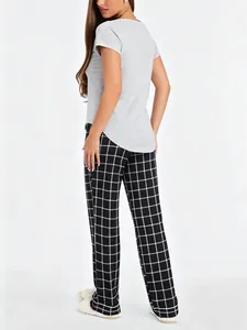 Back view of women's soft grey short sleeve top and black grid pajama pants set