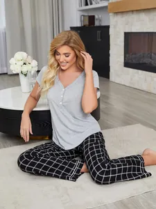 Comfortable two-piece women's pajama set featuring grey top and plaid pants detail