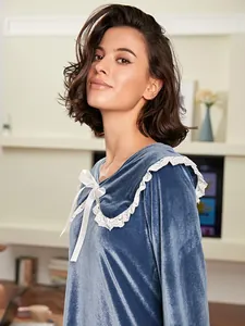 Detail showing soft velvet texture and white lace collar of a French nightgown.