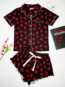 Detail of black women's pajamas set with red gift box patterns for Christmas holiday