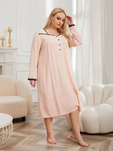 Plus size pink long sleeve nightgown with black lace trim details shown on a model