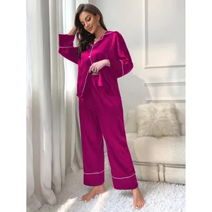 Elegant women's satin pajama set with long sleeve top and pants in magenta solid color
