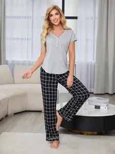 Stylish women's two-piece pajama set with grey short sleeve top and black plaid long pants