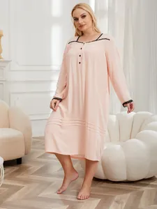 Elegant full-length plus size pink nightgown featuring delicate black lace trim and long sleeves