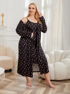 Plus-size black two-piece pajama robe set with white heart pattern in a cozy indoor setting