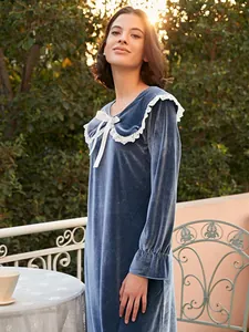 Detailed view of the soft blue velvet texture and exquisite white lace collar design
