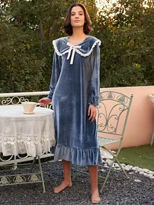 Elegant blue velvet long nightgown with white lace doll collar in outdoor garden setting