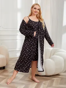 Close-up detail of plus size black nightgown and robe set with white heart print.