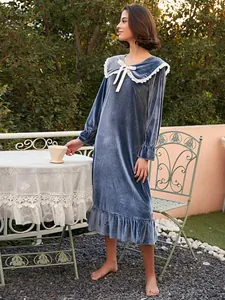 Elegant French style long blue velvet nightgown with lace collar in a garden setting