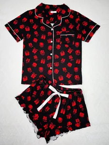 Detail of women's short-sleeve pajama set with red gift box print on black