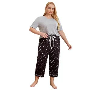 Plus size women's pajama set featuring a grey short sleeve top and heart print pants