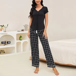 Two-piece women's pajama set with black short sleeve V-neck top and plaid long pants