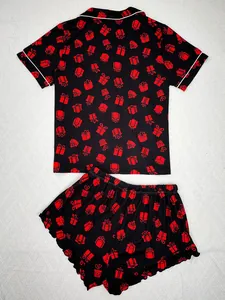 Detailed view of a black women's pajama set featuring festive red gift box prints